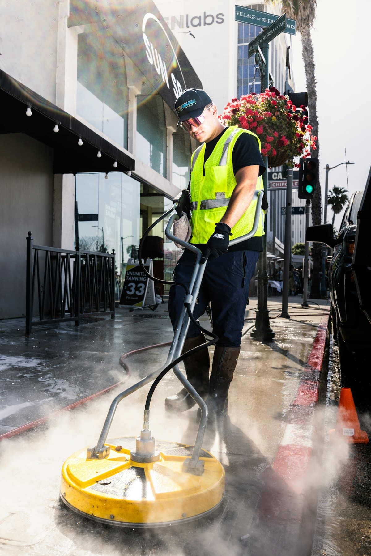 A cleaning team member in a high-visibility vest at work