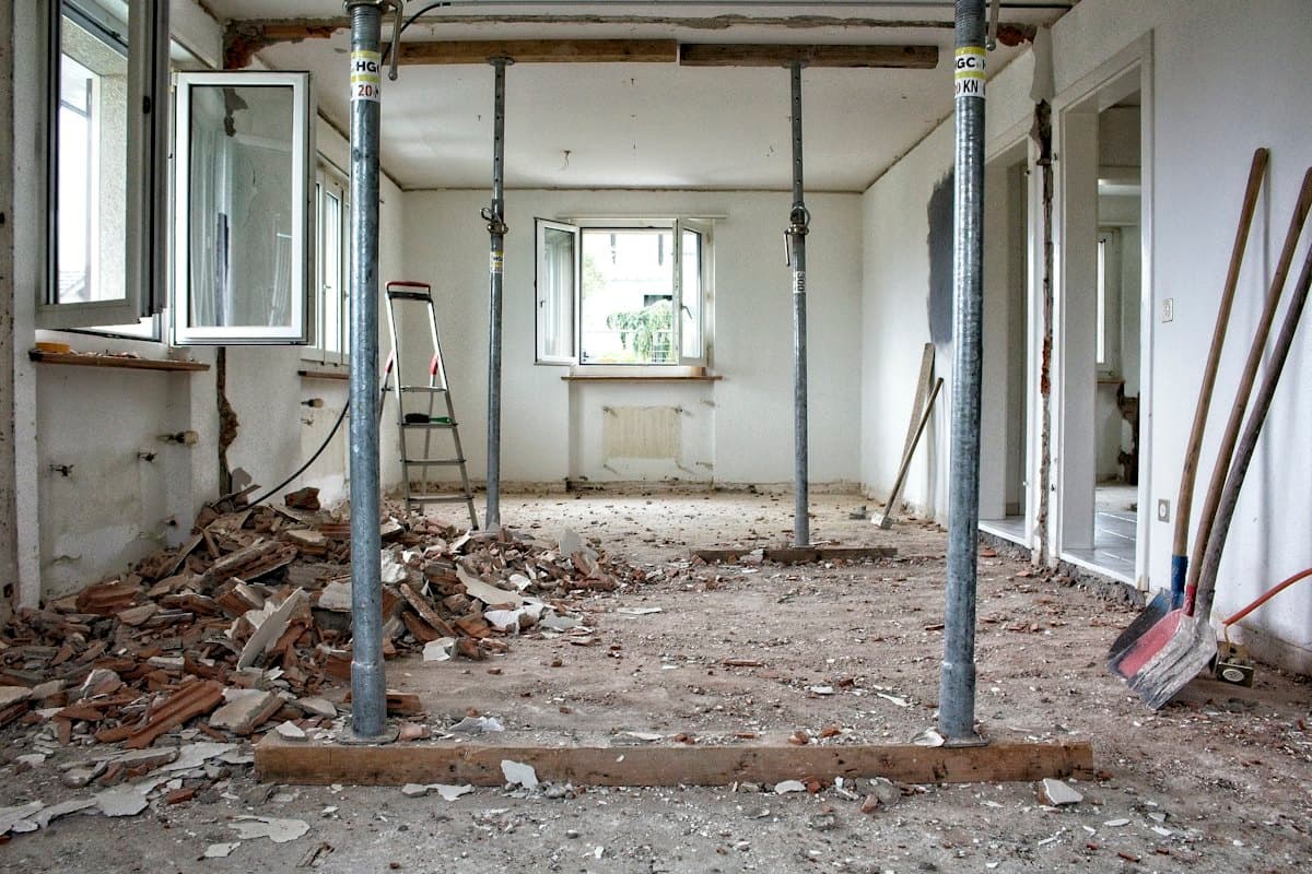 A room mid-renovation with rubble and builders' dust across the floor